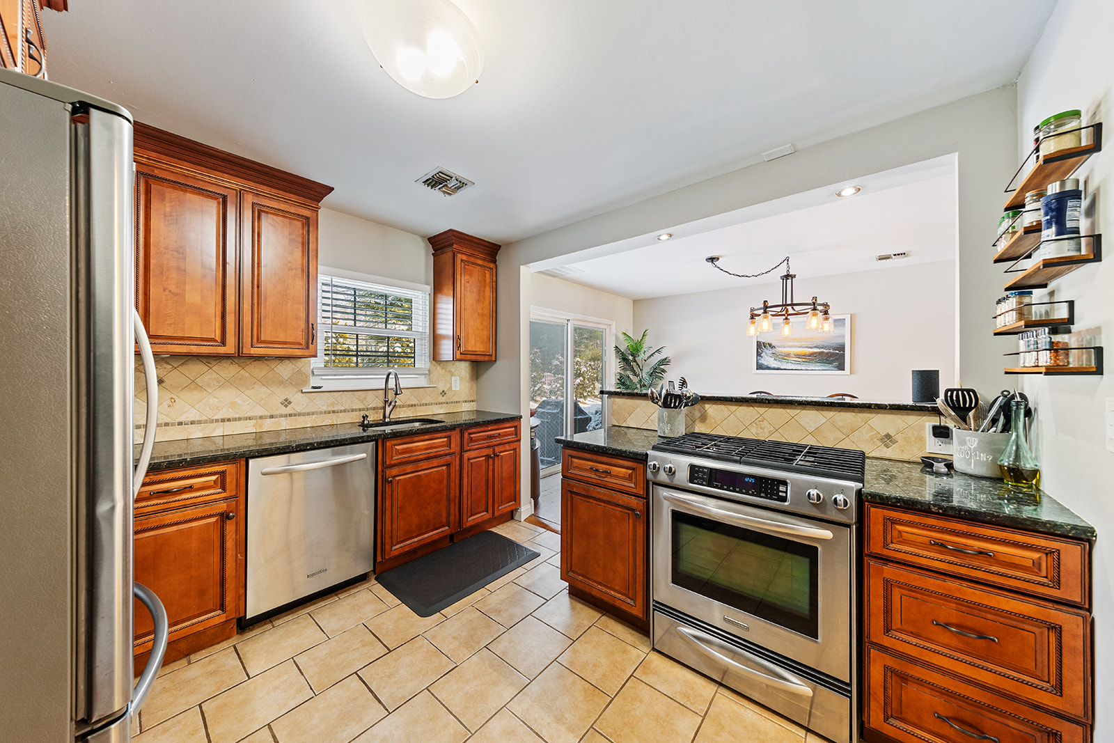 Modern kitchen with stainless steel appliances and granite countertops in a condo at 60 County Rd D22, Aberdeen Township, NJ
